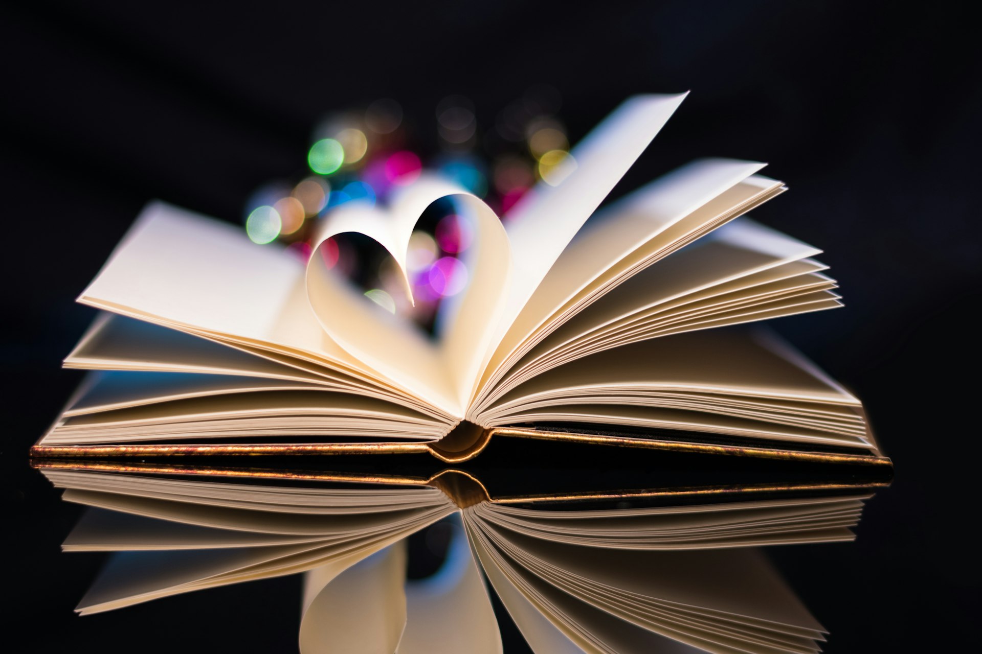 an open book with a heart shaped pages